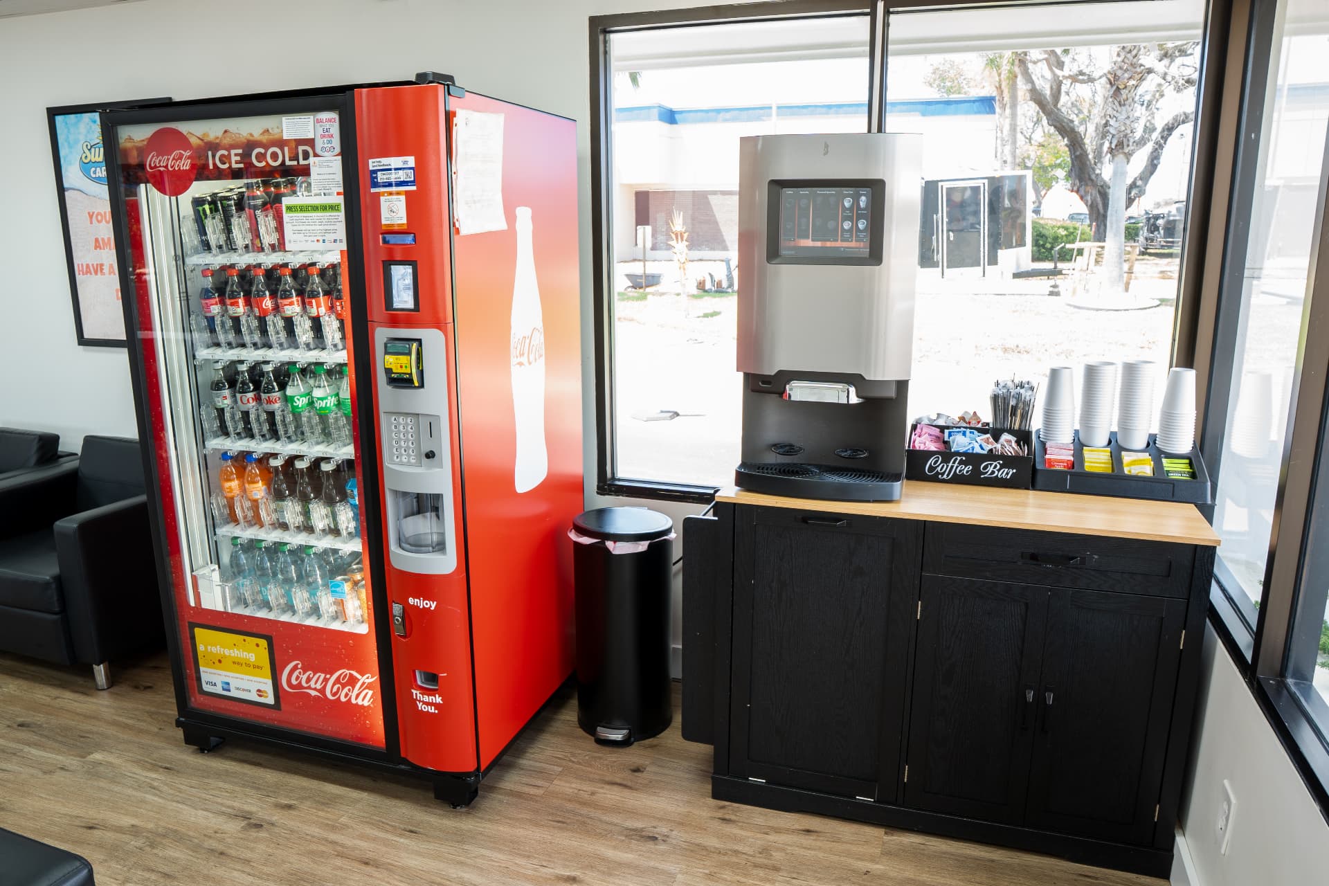 The complimentary coffee bar next to a Coca-Cola vending machine in the lounge