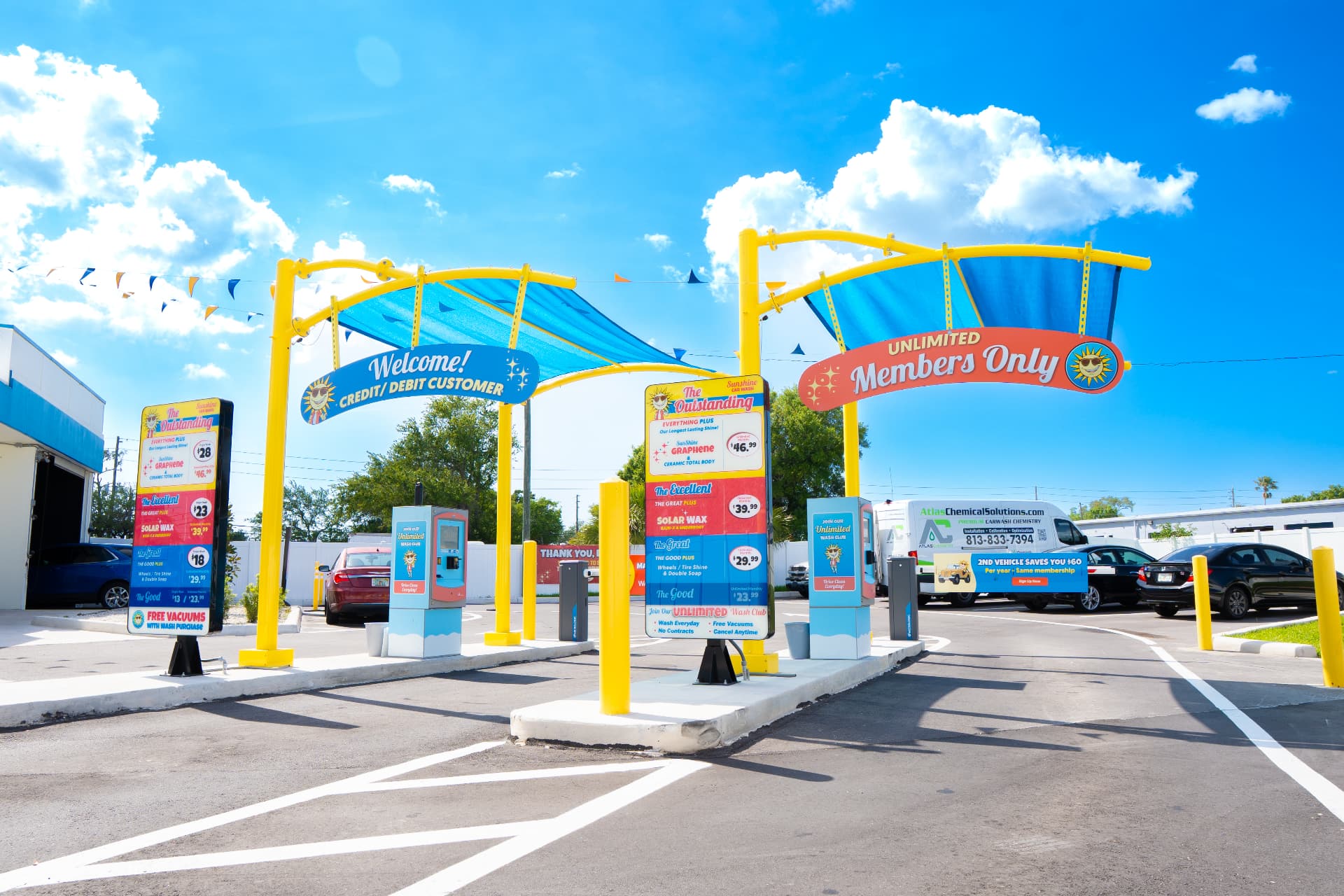 Customer and Unlimited Club entry lanes beneath blue canopies