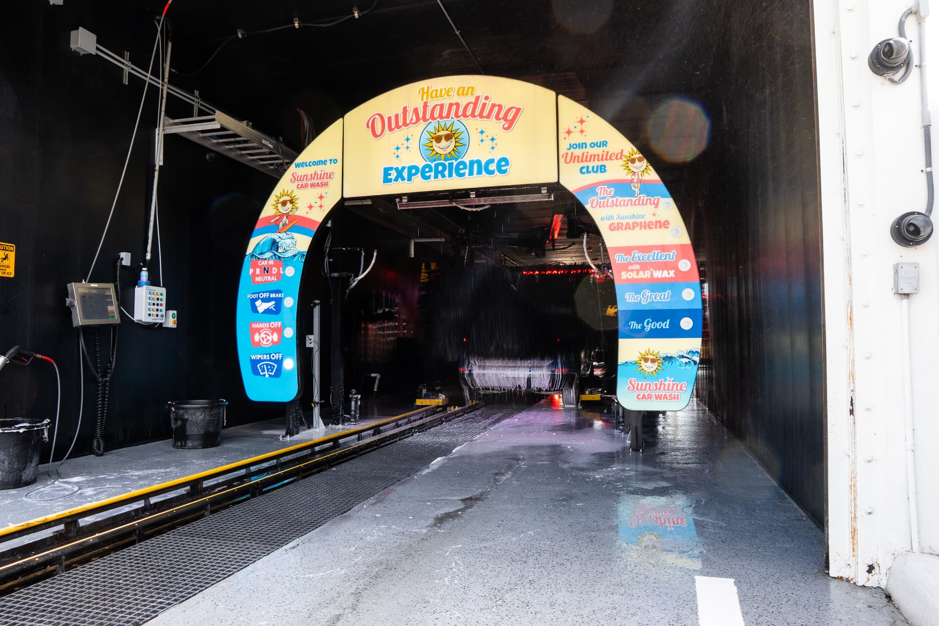 The Outstanding Experience arch at the entrance to the wash tunnel