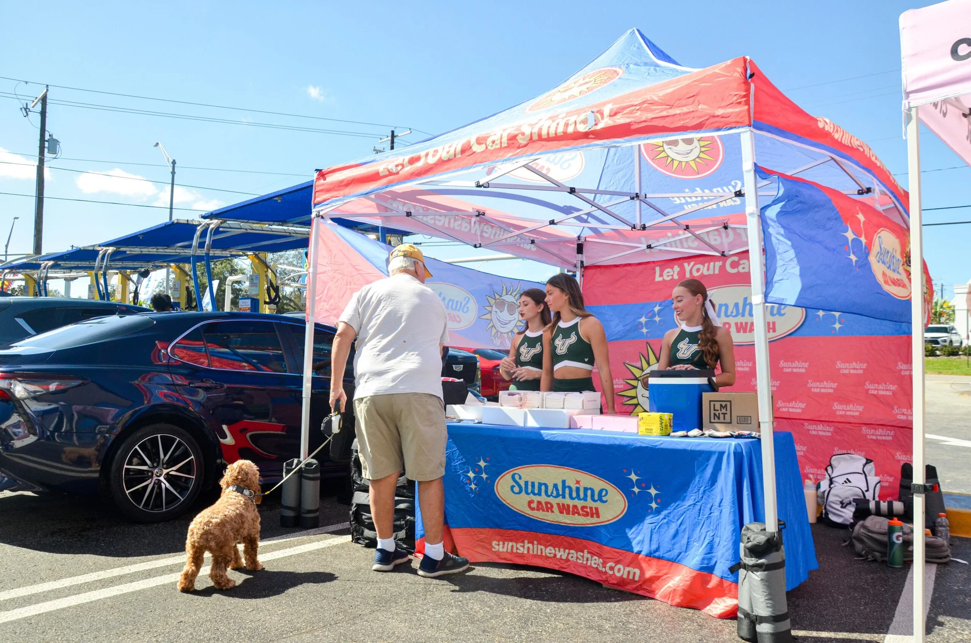 Sunshine Car Wash team welcoming a customer at the wash