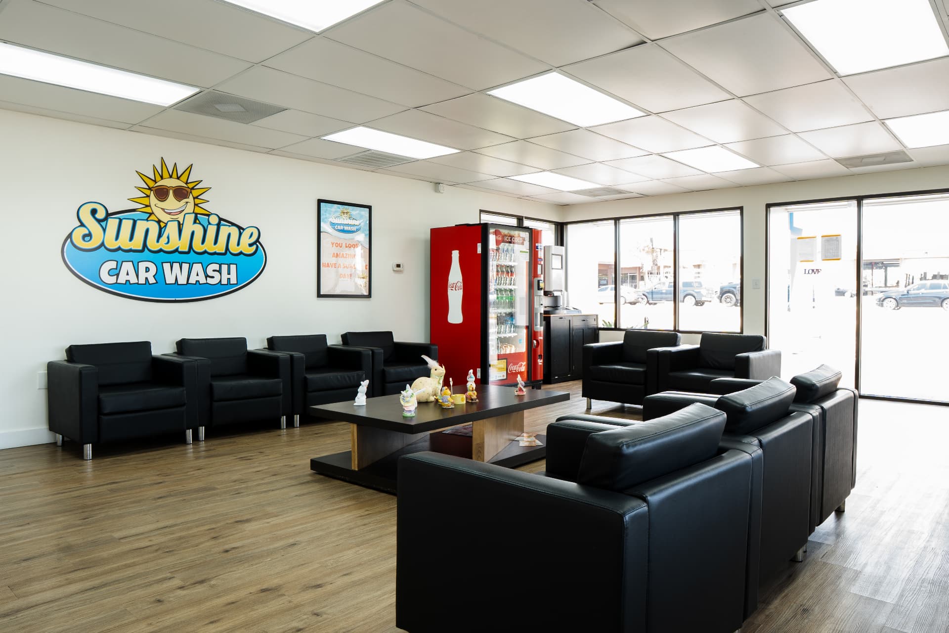 The indoor waiting lounge with leather seating and the Sunshine Car Wash wall sign