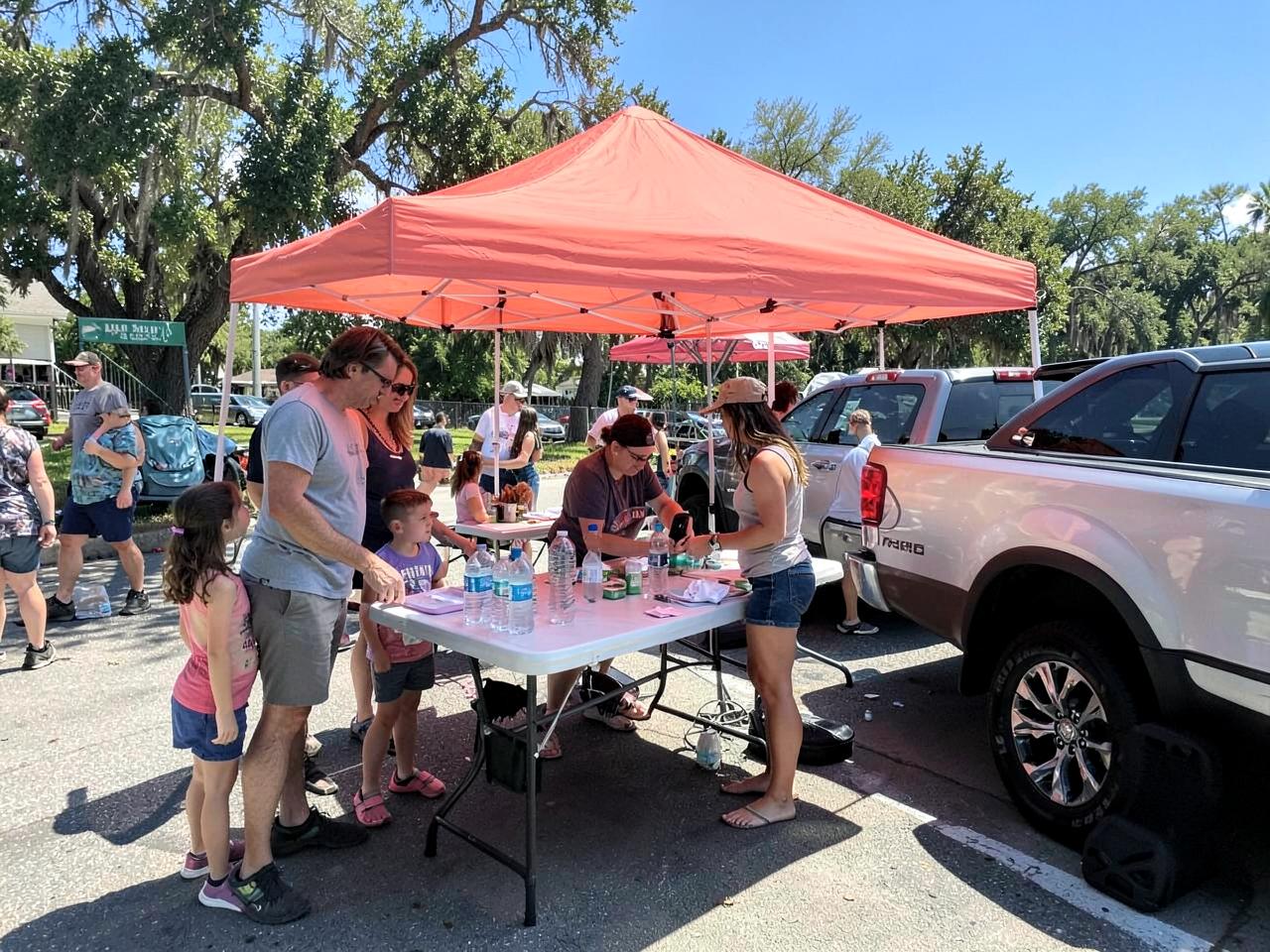 Sunshine crew members at a community event with families